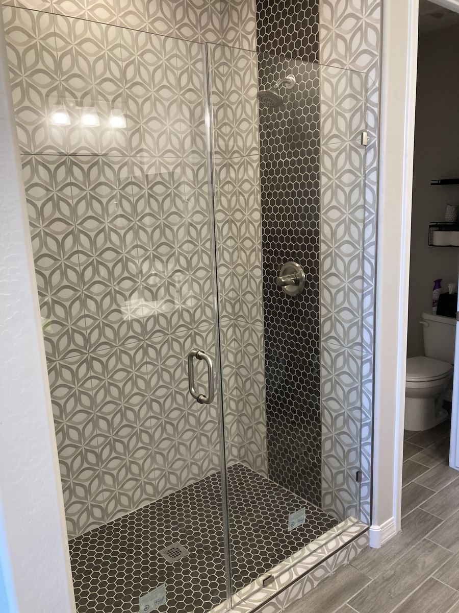 Hexagon mosaic walk-in shower with frameless glass