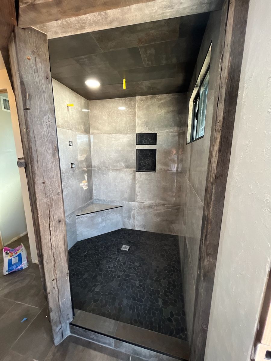 Walk-in shower framed in reclaimed wood