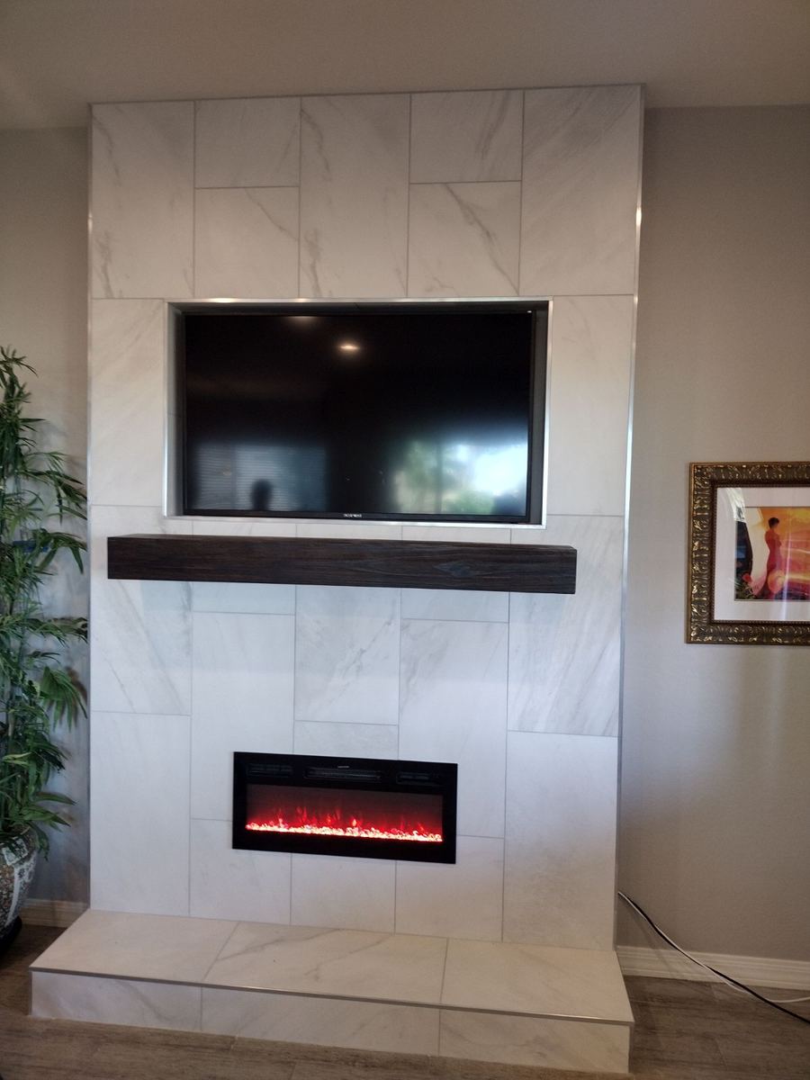 Floor to ceiling tile fireplace wall